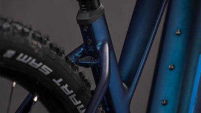 Die Nahaufnahme des CUBE Reaction Hybrid Pro 800 nebular'n'dazzle Trapeze 2026 zeigt den blauen Rahmen, das Sitzrohr, die markierte Sattelstützenklemme und den Hinterreifen mit SRAM-Branding. Ausgestattet mit Bosch CX Antrieb und einem 800 Wh Akku für Top-Trail-Performance.