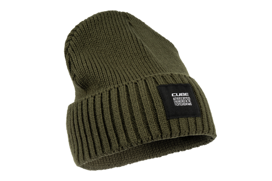 Die CUBE Beanie olive von Cube hat ein breites geripptes Umschlagbündchen und einen schwarzen rechteckigen Aufnäher mit weißem Text. Erhältlich im CUBE Store Göttingen, die Mütze ist auf einem schlichten weißen Hintergrund abgebildet.