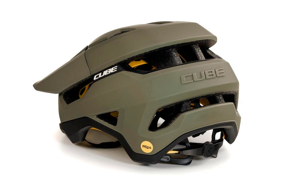 Der Cube CUBE Helm TROOPER ist ein matt olivgrüner Enduro-Helm mit schwarzen und gelben MIPS-Akzenten, einem verstellbaren Drehknopf auf der Rückseite und mehreren Belüftungskanälen für optimale Luftzirkulation.