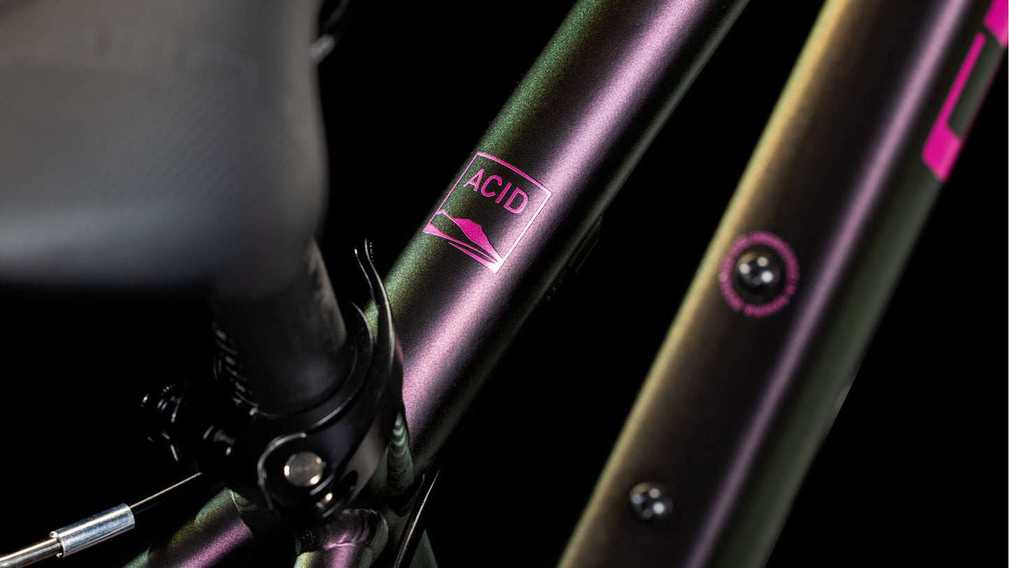 Nahaufnahme des CUBE Acid 200 molotov'n'pink 2025 Rahmens mit irisierender Lackierung und einem 6061 Aluminiumrahmen, der das ACID Label neben einer stilisierten Berggrafik zeigt. Die Details dieses CUBE-Bikes sind scharf umrissen.