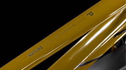 Eine Nahaufnahme des Cube Nature Pro Allroad willowgreen'n'black Trapeze 2025 von CUBE zeigt den leichten Aluminiumrahmen mit den Schriftzügen "NATURE", "SHAPE 1", "WHEELS 29", "PRO" und einem markanten "P" in schwarzer Schrift vor einem schlichten schwarzen Hintergrund.