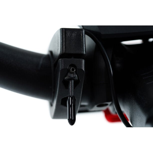 Nahaufnahme eines ACID FILink Adapter für Lenker in schwarz von ACID an einem Lenker befestigt, mit Teil der Lenkerbefestigung und Zündschlüssel sichtbar.